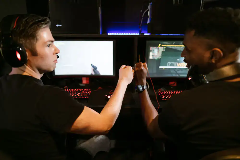 Two players fist bumping after an esports match